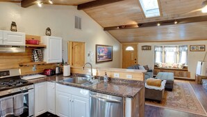 A modern kitchen with white cabinets, stainless steel appliances, and a granite countertop. - Tahoe Home 3 Mi to Heavenly Mountain Resort! (Stateline)