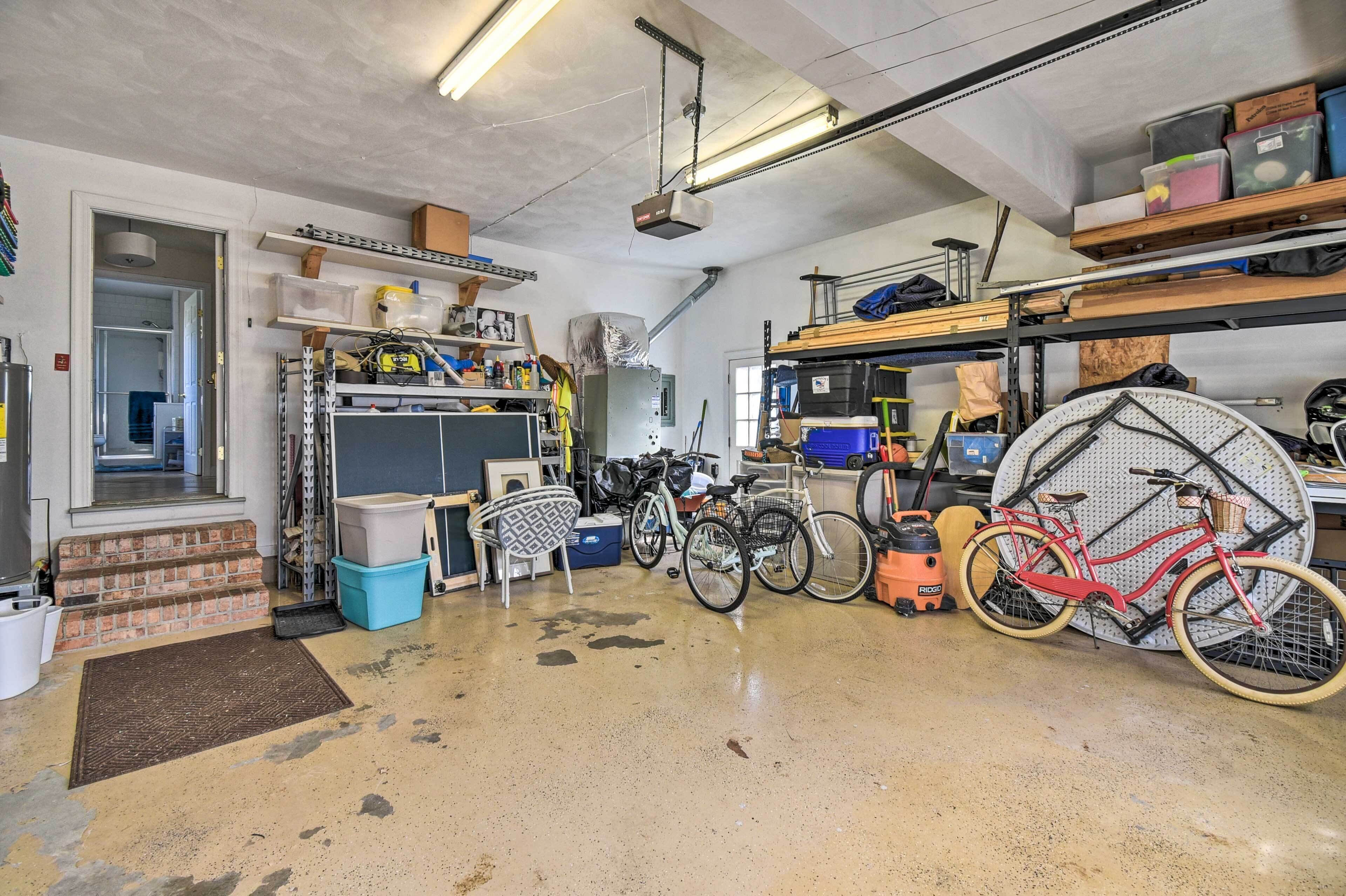 A garage with bicycles, shelves, and various tools.