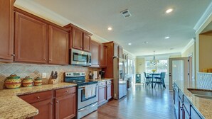 A modern kitchen with wooden cabinets, stainless steel appliances, and a granite countertop. - Spacious Kathleen Vacation Rental w/ Fireplace (Kathleen)