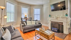 A living room with a gray sofa, a coffee table, and a fireplace. - Airy Vacation Rental in Augusta, Georgia! (Augusta)