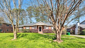 A residential house with a front lawn, a brick facade, and a front door. - Decatur Apartment w/ Tennis Court ~ 11 Mi to ATL (Decatur)