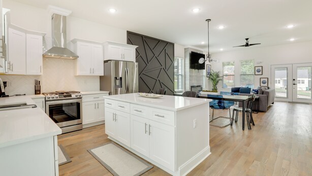 A modern kitchen with white cabinetry, a central island, and a built-in oven. - Modern Decatur Home ~ 7 Mi to Atlanta! (Decatur)