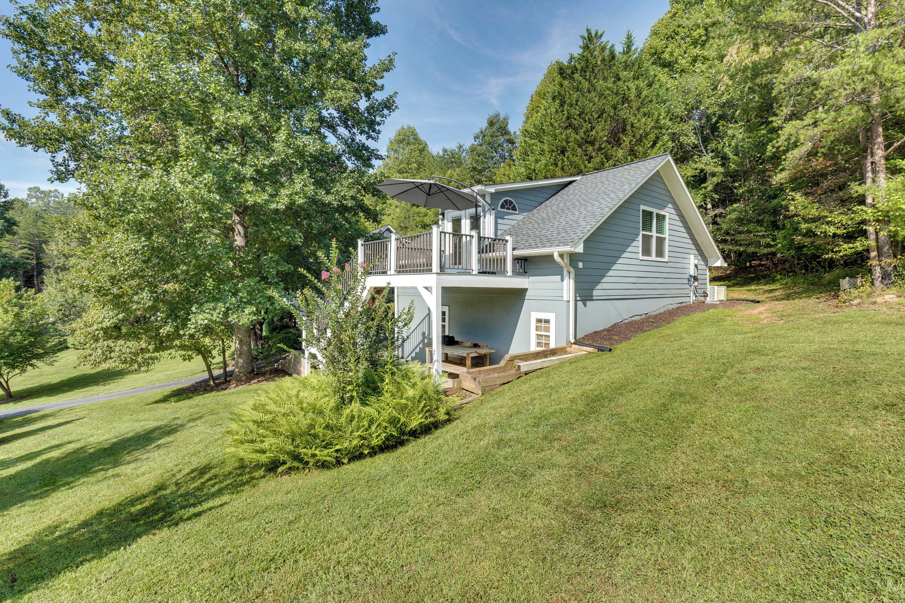 A two-story house with a covered deck and a small porch.