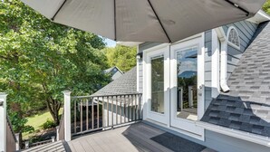 A covered deck with a view of a house, a staircase, and a garden. - Young Harris Vacation Rental w/ Mountain Views! (Young Harris)
