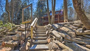 A wooden staircase leading up to a cabin surrounded by trees. - Private Cartecay River Home w/ Hot Tub & Game Room (Ellijay)