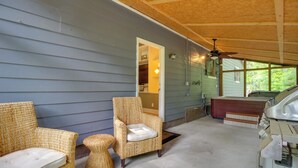 A covered porch with wicker furniture, a ceiling fan, and a carport. - Southern Escape in Guyton: Private Yard & Hot Tub! (Guyton)