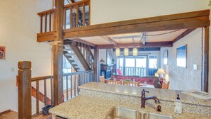A kitchen with granite countertops, stainless steel sink, and wooden beams. - 1 Mi to Stagecoach Lift! Homey Tahoe Townhome (Stateline)
