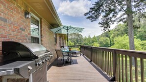 A covered patio with a grill, outdoor furniture, and a view of a wooded area. - Cozy Georgia Getaway w/ Deck, Grill & Fire Pit! (Cartersville)