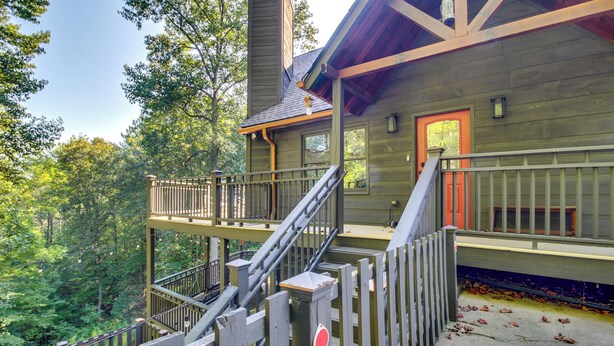 A wooden cabin with a balcony, surrounded by trees. - Spacious Ellijay Resort Home w/ Hot Tub! (Ellijay)