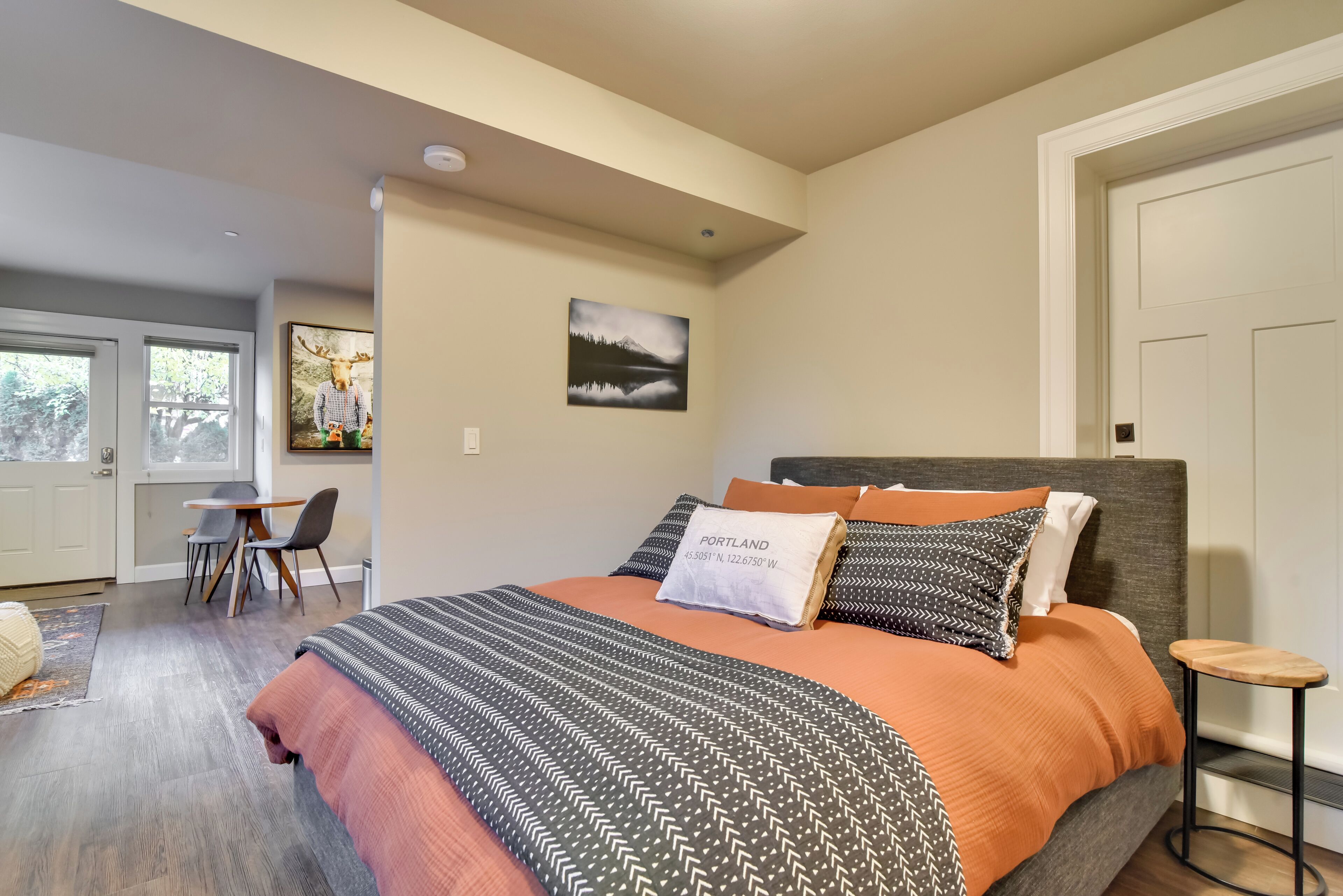 A bedroom with a bed, a desk, and a chair.
