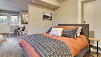 A bedroom with a bed, a desk, and a chair.