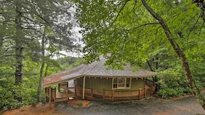 A rustic cabin with a porch, surrounded by dense forest. - Mountain Resort Home w/ Views, By Sky Valley Golf! (Dillard)