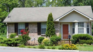 A two-story house with a brick facade, a gabled roof, and a front porch. - Lively East Nashville Pad: Walk to Bars & Eateries (Nashville)