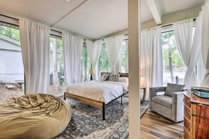 A bedroom with a bed, a bean bag, a chair, and a dresser. - Eatonton Getaway on Lake Sinclair w/ Dock! (Milledgeville)
