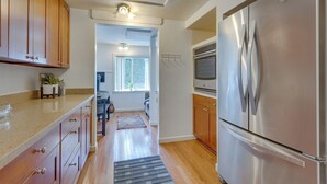 A kitchen with wooden cabinets, a stainless steel refrigerator, and a microwave. - Bright & Airy Seattle Abode < 9 Mi to Space Needle (Seattle)