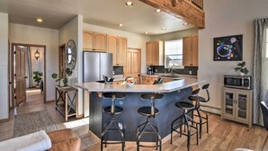 A spacious kitchen with a central island, wooden cabinets, and a modern design. - 503 Mountain Loft w/ Views: 1 Mi to Dwtn Fairplay! (Fairplay)