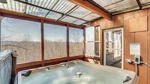 A hot tub with a view of mountains through large windows. - Pool, Hot Tub & Mountain Views: Cleveland Cabin (Cleveland)