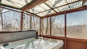 A hot tub with a glass enclosure, wooden deck, and a view of trees and mountains. - Pool, Hot Tub & Mountain Views: Cleveland Cabin (Cleveland)