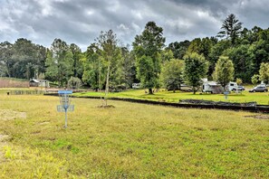 A campground with RVs, a disc golf course, and a small cabin. - Secluded Morganton Tiny Home w/ Grills! (Morganton)