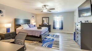 A modern bedroom with a bed, desk, chair, nightstands, dresser, and a ceiling fan. - Conyers Vacation Rental w/ Pool: 5 Mi to Olde Town (Conyers)