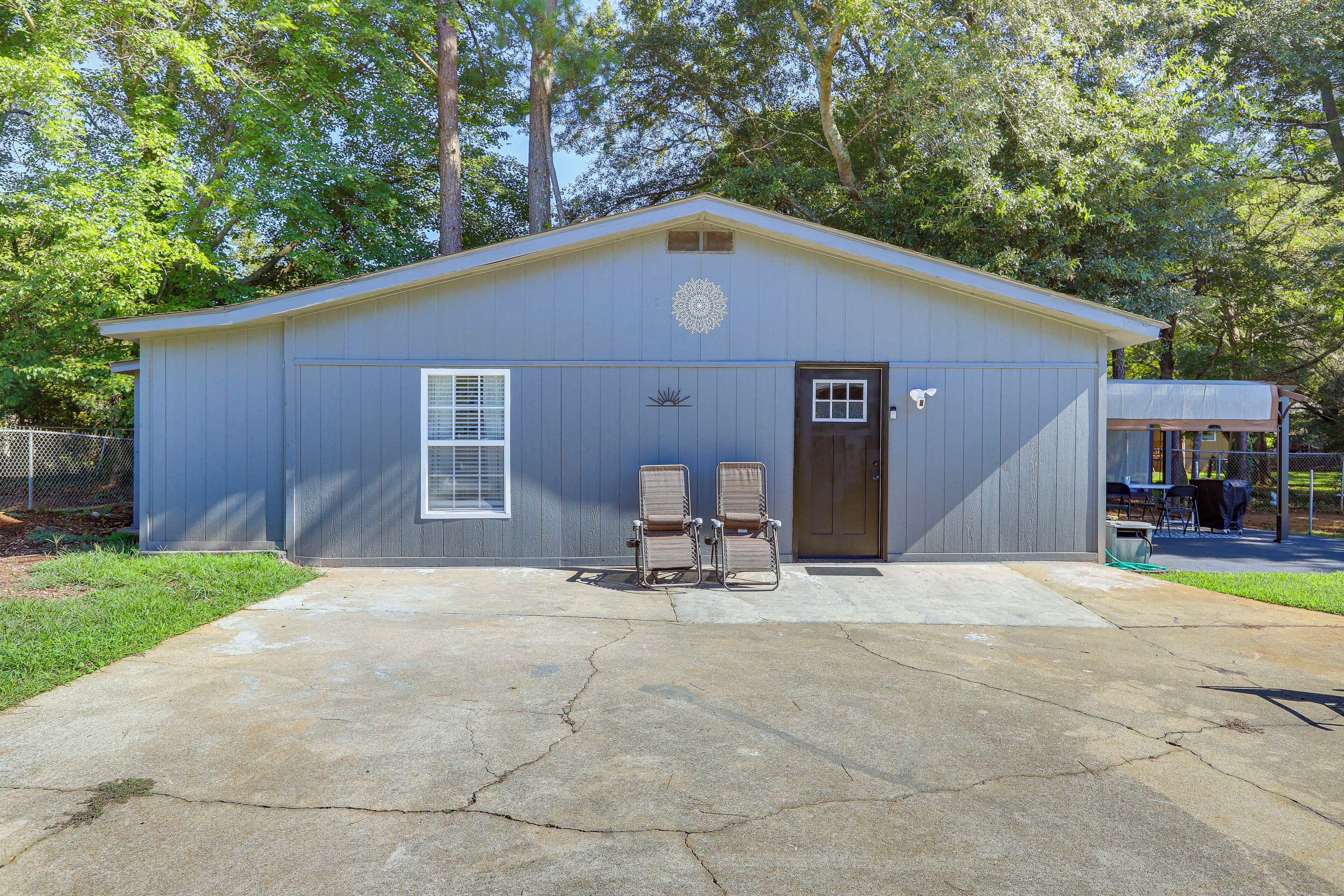 A single-story building with a gabled roof, a door, and two windows.