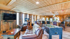 A cozy room with a wooden ceiling, a foosball table, leather sofas, and a flat-screen TV. - Game Room, Mtn Views! Unit 1 Mi to Heavenly Resort (Stateline)