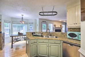 A kitchen with granite countertops, a stainless steel sink, and a vintage-style microwave. - Martinez Retreat w/ Seasonal Pool: 9 Mi to Masters (Grovetown)