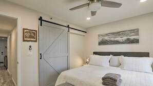 A bedroom with a large bed, a sliding door, a ceiling fan, and a painting on the wall. - < 1 Mi to Slopes! 'heavenly Daze Chalet' in Tahoe (Stateline)