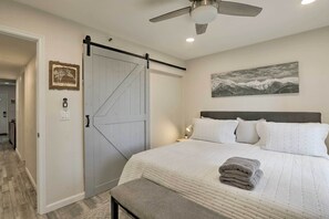 A bedroom with a large bed, a sliding door, a ceiling fan, and a painting on the wall. - < 1 Mi to Slopes! 'heavenly Daze Chalet' in Tahoe (Stateline)