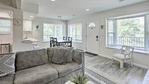 A spacious living room with a gray sectional sofa, a dining area with a table and chairs, and large windows with white blinds. - < 1 Mi to Slopes! 'heavenly Daze Chalet' in Tahoe (Stateline)