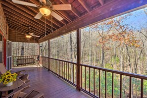 A wooden deck with a railing, a table with chairs, and a bench. - Family-friendly Cabin ~ 1 Mile to Hike & Swim! (Blairsville)