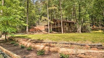 A rustic cabin surrounded by a forest.