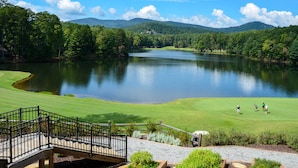 A golf course with a lake, surrounded by trees and hills. - Luxe Big Canoe Resort Home w/ 3 Decks & Mtn Views! (Dawsonville)