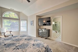 A bedroom with a large bed, a dresser, a TV, and a walk-in closet. - Updated Mableton Home ~ 14 Miles to Downtown Atl! (Mableton)