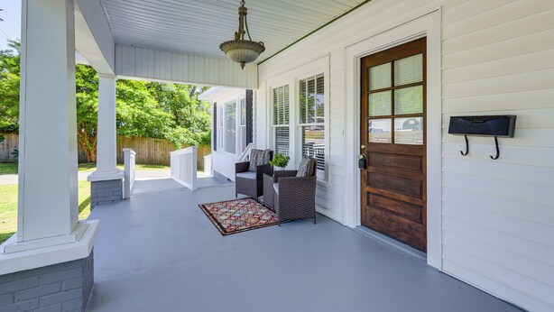 A covered porch with a white railing, a wooden door, and a hanging light fixture. - Main Street Home: 1 Mi to Callaway Gardens (Pine Mountain)