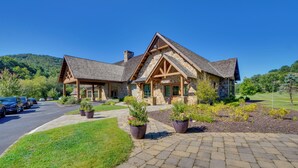 A large, stone building with a prominent entrance and a well-maintained lawn. - Stunning Dillard Home w/ Yard in Sky Valley! (Dillard)
