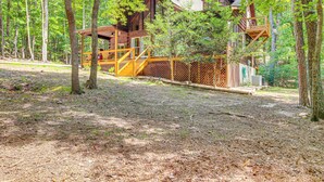 A cabin with a wooden exterior, a deck, and a covered porch. - North Georgia Cabin w/ Hot Tub & Community Perks! (Jasper)