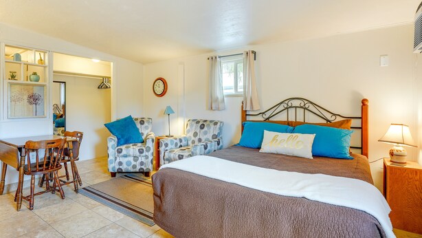 A bedroom with a large bed, a desk, and two chairs. - Budget-friendly Tucson Studio: 2 Mi to University! (Tucson)