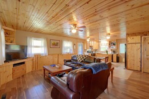 A wooden interior with a living room, a television, and a kitchen area. - Hot Tub & Fire Pit: Pet-friendly Clayton Escape! (Clayton)