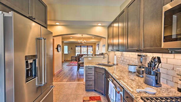 A modern kitchen with stainless steel appliances, granite countertops, and a central island. - 7984: Pet-friendly Townhome w/ Grill! (Salida)
