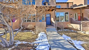 A two-story house with a blue door and a small balcony. - 7984: Pet-friendly Townhome w/ Grill! (Salida)