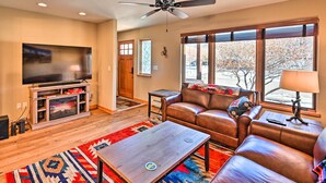 A living room with a flat-screen TV, leather sofa, and a coffee table. - 7984: Pet-friendly Townhome w/ Grill! (Salida)