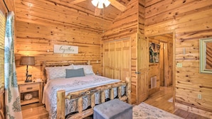 A wooden cabin bedroom with a bed, nightstand, and a sign that reads "Together". - Cozy Hiawassee Cabin w/ Fire Pit & Mtn Views! (Hiawassee)