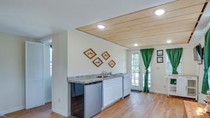 A spacious kitchen with wooden flooring, a built-in dishwasher, and a countertop with a sink. - Relaxing Buena Vista Getaway w/ Lush Lake Views (Buena Vista)
