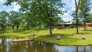 A lakeside cabin with a dock, surrounded by trees and a grassy area. - Relaxing Buena Vista Getaway w/ Lush Lake Views (Buena Vista)