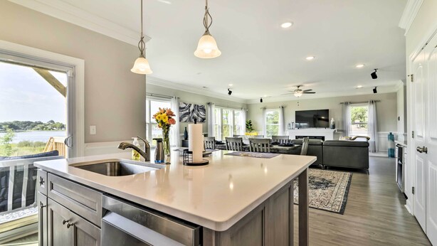A modern kitchen with a large island, stainless steel appliances, and pendant lighting. - Waterfront Paradise w/ Deck ~ 1/2 Mi to Beach (Norfolk)