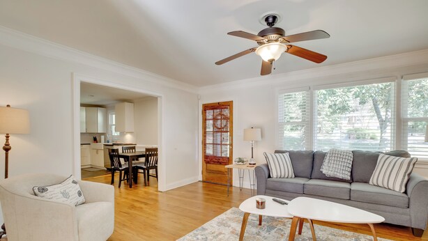 A living room with a gray sofa, a white armchair, a coffee table, and a ceiling fan. - Contemporary Athens Home < 2 Miles to Uga! (Athens)