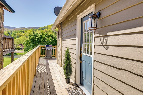 A wooden deck with a blue door and a satellite dish. - Charming Condo on Sky Valley Golf Course! (Dillard)