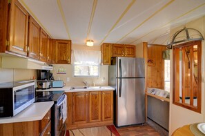 House (2 Bedrooms) | Private kitchen | Cookware/dishes/utensils, paper towels - Cozy Tennessee Escape w/ Porch, Grill & Fire Pit! (Byrdstown)