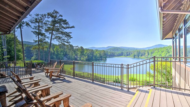 A wooden deck with outdoor seating, a view of a lake, and a forested landscape. - Big Canoe Retreat w/ Deck & Golf Course Views (Jasper)